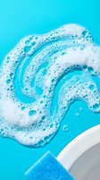 Swirling white foam and bubbles in bright blue water creating dynamic cleaning motion for household and hygiene product advertising campaigns.