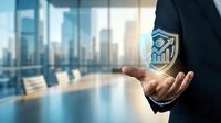 Businessman in dark suit holding glowing holographic shield icon with upward growth chart, modern office cityscape background, representing data security and financial protection.