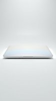 Slim closed laptop with glossy white lid isolated on light background, showcasing modern portable computer design for tech and business use.