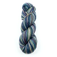 Twisted skein of multicolored yarn in shades of blue, purple, and cream, isolated on white background for knitting and crochet projects.