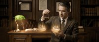 Professional middle-aged Caucasian male lawyer in dark suit holding golden scales of justice in elegant law office with books and green banker lamp.