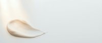 Creamy cosmetic texture smear on white background, skincare product sample for beauty and wellness applications.