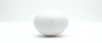 Single white egg isolated on light background, suitable for food, nutrition, cooking, and culinary design projects.