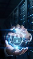 Cybersecurity professional holding glowing digital padlock shield with keyhole in hands against server room background, representing data protection and network security.