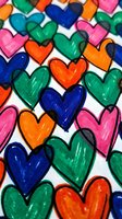 Colorful hand-drawn hearts pattern with vibrant markers in blue, green, orange and pink creating artistic love symbols for romantic designs.