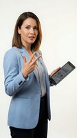 Professional businesswoman in blue blazer presenting tablet device with pointing gesture on white background for corporate marketing materials.