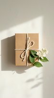 Kraft paper gift box tied with twine and white jasmine flowers on a light background, soft shadows, eco-friendly packaging concept.