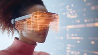 Young African American woman wearing futuristic augmented reality glasses with orange holographic display, curly hair and pink turtleneck against blue background with bokeh effects.
