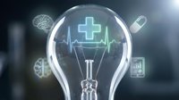 Healthcare innovation lightbulb with medical cross and heartbeat line surrounded by floating medical icons representing digital health technology solutions.