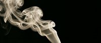 White smoke swirls gracefully against black background creating elegant flowing patterns for artistic and atmospheric design projects.