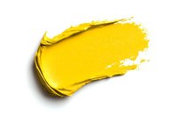 Yellow cosmetic cream smear isolated on white background, textured makeup product swatch showing rich pigment and creamy consistency for beauty and cosmetics design.