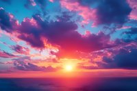 Dramatic sunset sky with vibrant purple and pink clouds over calm ocean horizon, sun setting with golden light creating magical atmospheric scene.