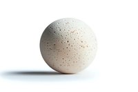 Round white bath bomb with textured surface and small speckles isolated on white background, ready for spa and wellness product marketing.
