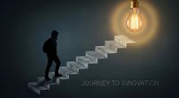 Businessman silhouette climbing stairs toward glowing lightbulb representing journey to innovation and creative success in business development.