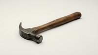 Vintage wooden handle claw hammer isolated on white background, rustic old metal tool for construction and carpentry work.