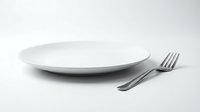 Empty white ceramic plate with a silver fork on a white background, symbolizing dining, hunger, diet, or minimalist food concepts.