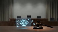 Digital justice concept with glowing scales hologram on laptop screen in modern courtroom setting with wooden gavel for legal technology presentations.
