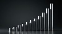 Silver metallic cylindrical bars arranged in ascending staircase pattern showing growth progression on dark background for business presentations.
