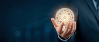 Businessman in dark suit holding glowing globe with network connections, representing global business, technology innovation, and international commerce opportunities.