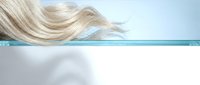 Flowing blonde hair in motion against soft blue and white gradient background with dynamic movement and natural texture for beauty and wellness concepts.