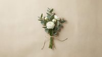 Small white rose bouquet with eucalyptus leaves tied with twine on neutral beige background for wedding decor and floral arrangements.