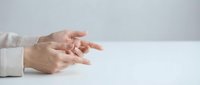 Professional businesswoman hands gesturing during presentation or meeting on clean white desk surface for corporate communication concepts.