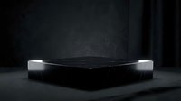 Minimalist black marble podium platform with metallic edges against dark textured wall background for luxury product display and presentation.