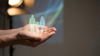 Holographic family figures floating above open palm representing digital protection, insurance coverage, and modern healthcare technology solutions.