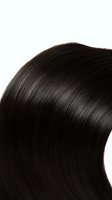 Close-up of glossy dark brown hair with smooth texture and natural wave pattern against white background, showing healthy shine and silky appearance.