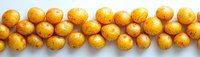 Fresh yellow baby potatoes arranged in neat rows on white background, showing natural organic produce with earthy texture and golden skin. Suitable for food blogs and recipe sites.