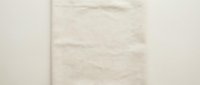 Neutral beige fabric texture with horizontal seam detail on light background for interior design and textile applications.