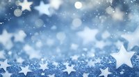 Dreamy winter background with glowing white stars and bokeh lights on sparkling blue surface. Festive holiday season backdrop with magical starry pattern.
