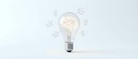 Glowing light bulb with brain filament surrounded by floating icons on white background representing innovation, creativity and bright ideas for business concepts.