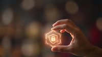 Person holding glowing security lock icon with digital light effect against blurred background. Concept for cybersecurity, data protection, and network safety solutions.