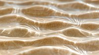 Rippling sand dunes with light and shadow creating mesmerizing wave patterns in desert landscape, abstract natural background texture for environmental designs.