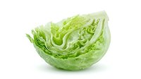 Fresh green cabbage wedge with water droplets isolated on white background, suitable for food, nutrition, cooking, and healthy eating design projects.