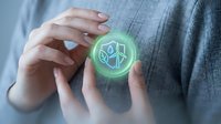 Hands holding glowing green circular icon with leaf and renewable energy symbols, representing sustainability, eco-friendly technology, and environmental conservation for business and corporate use.