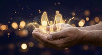 Glowing family silhouettes held in protective cupped hands against dark background with golden bokeh lights symbolizing care, protection and love.