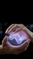Hands protecting glowing purple energy wave on dark background symbolizing power, innovation and futuristic technology concepts.