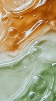 Abstract liquid texture with flowing orange and green colors creating organic bubbles and swirls for modern design backgrounds and artistic projects.