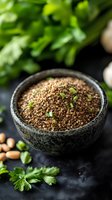 Raw brown quinoa seeds in stone bowl garnished with fresh herbs and scattered nuts on dark background, macro food photography for healthy eating concept.