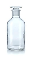 Clear glass reagent bottle with ground glass stopper isolated on white background for laboratory equipment and scientific research applications.