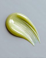 Glossy lime green cosmetic cream smear texture on gray background, showing smooth skincare product consistency and luxurious sheen for beauty industry use.