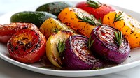 Grilled colorful vegetables with herbs and spices on white plate, including tomatoes, onions, bell peppers, and zucchini garnished with fresh rosemary.