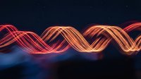 Abstract glowing wave lines in red and orange colors flowing across dark blue background for digital technology and energy concepts.