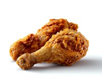 Crispy golden fried chicken legs with crunchy breading isolated on white background, showcasing deep-fried comfort food with textured, flaky coating.