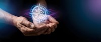 Hands holding glowing geometric compass symbol with mystical energy effects for spiritual guidance and navigation concepts.