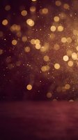 Golden bokeh lights floating over dark burgundy surface creating warm festive atmosphere for holiday celebrations and luxury events.