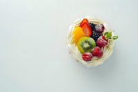 Fresh mixed fruits in wicker basket on white background including strawberry kiwi orange and berries for healthy eating and nutrition concepts.