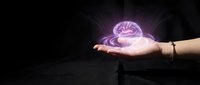 Glowing pink brain hologram floating above open palm against dark background representing artificial intelligence, neuroscience and mental health concepts.